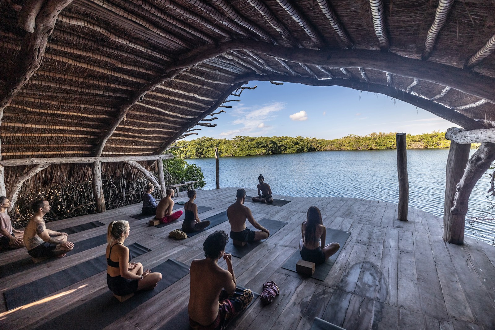 a group of people sitting on top of a wooden floor